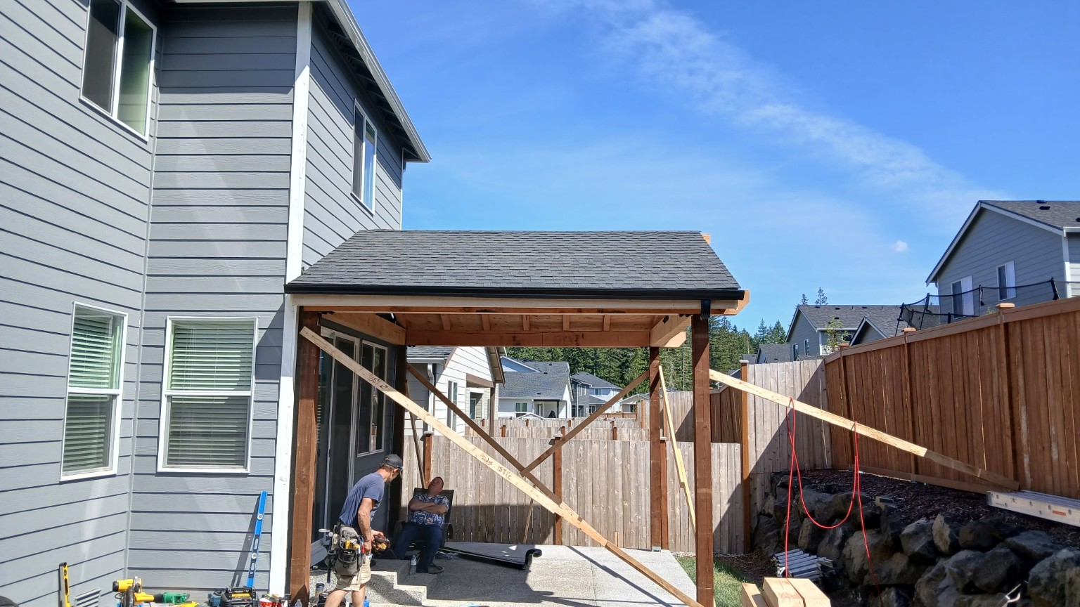 Timber patio cover under construction with temporary bracing