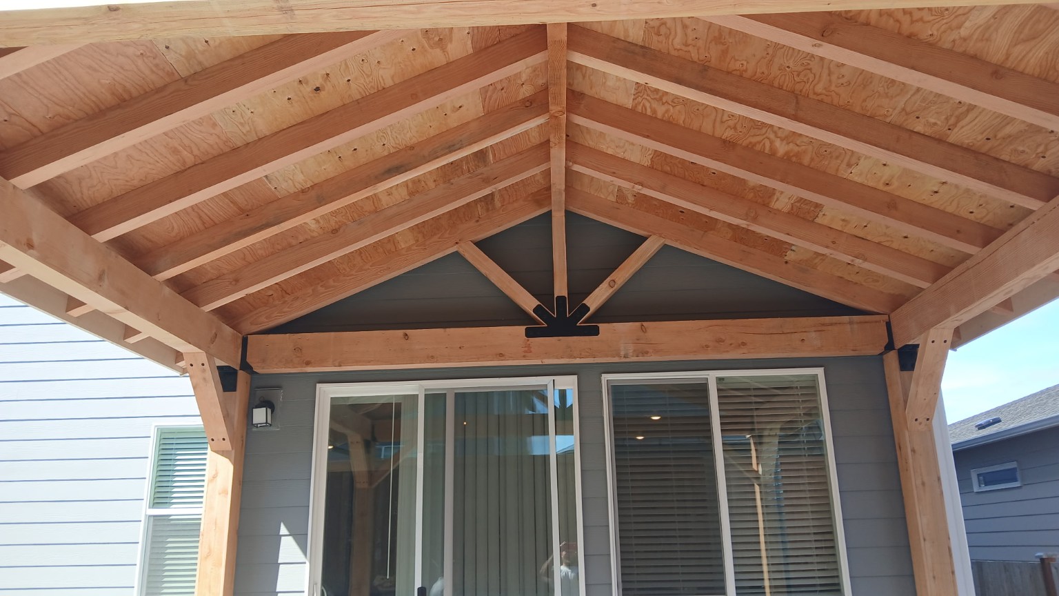 Finished patio cover built against the rear wall of the home