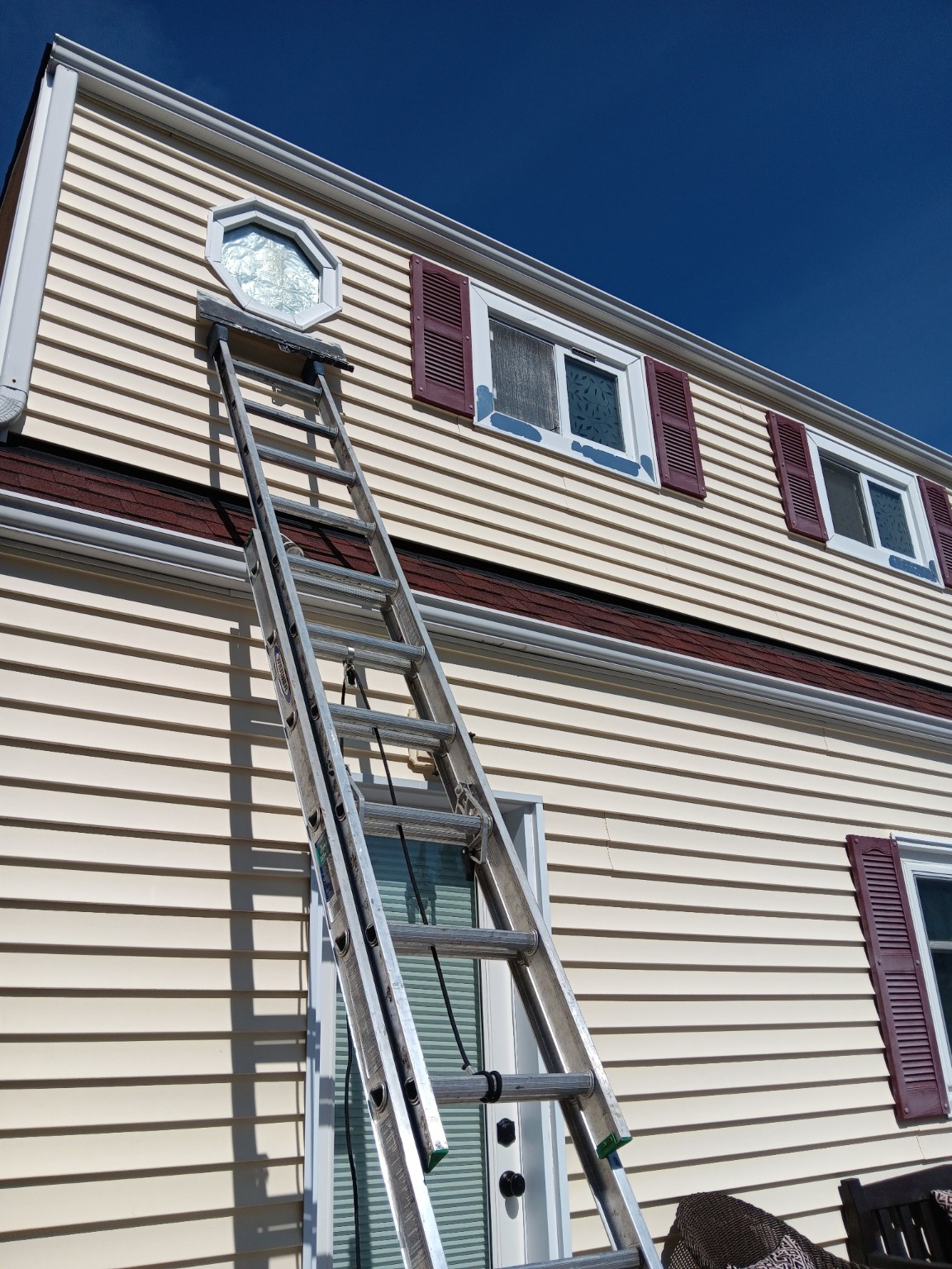 Second-story exterior window trim before restoration