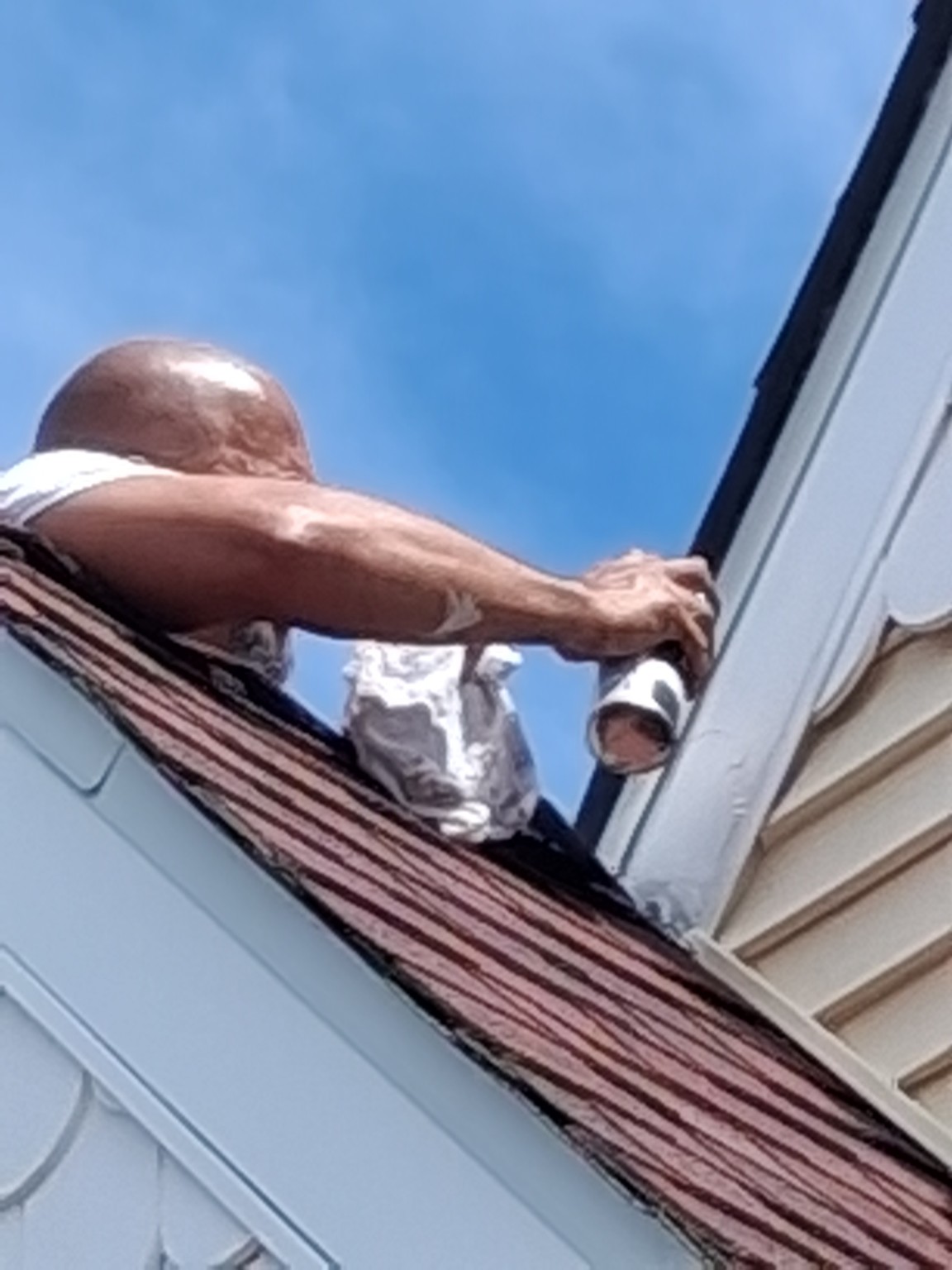Exterior trim painting along the front roofline