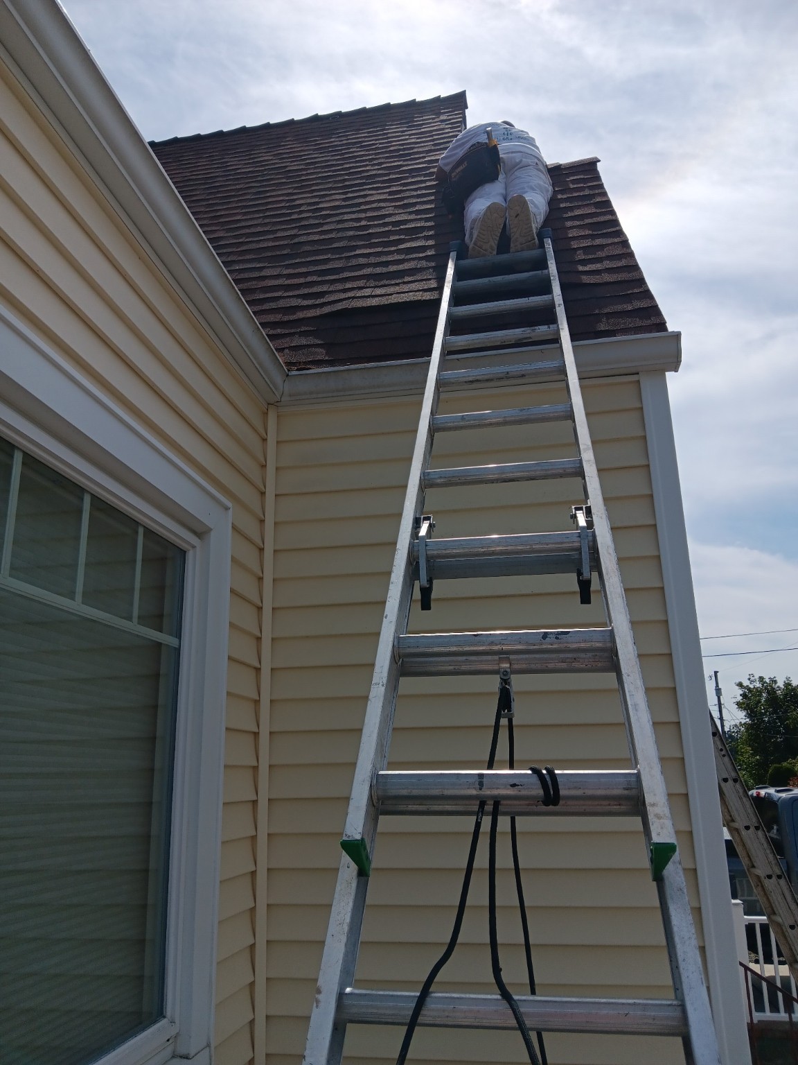 High-access exterior repair work near the roofline
