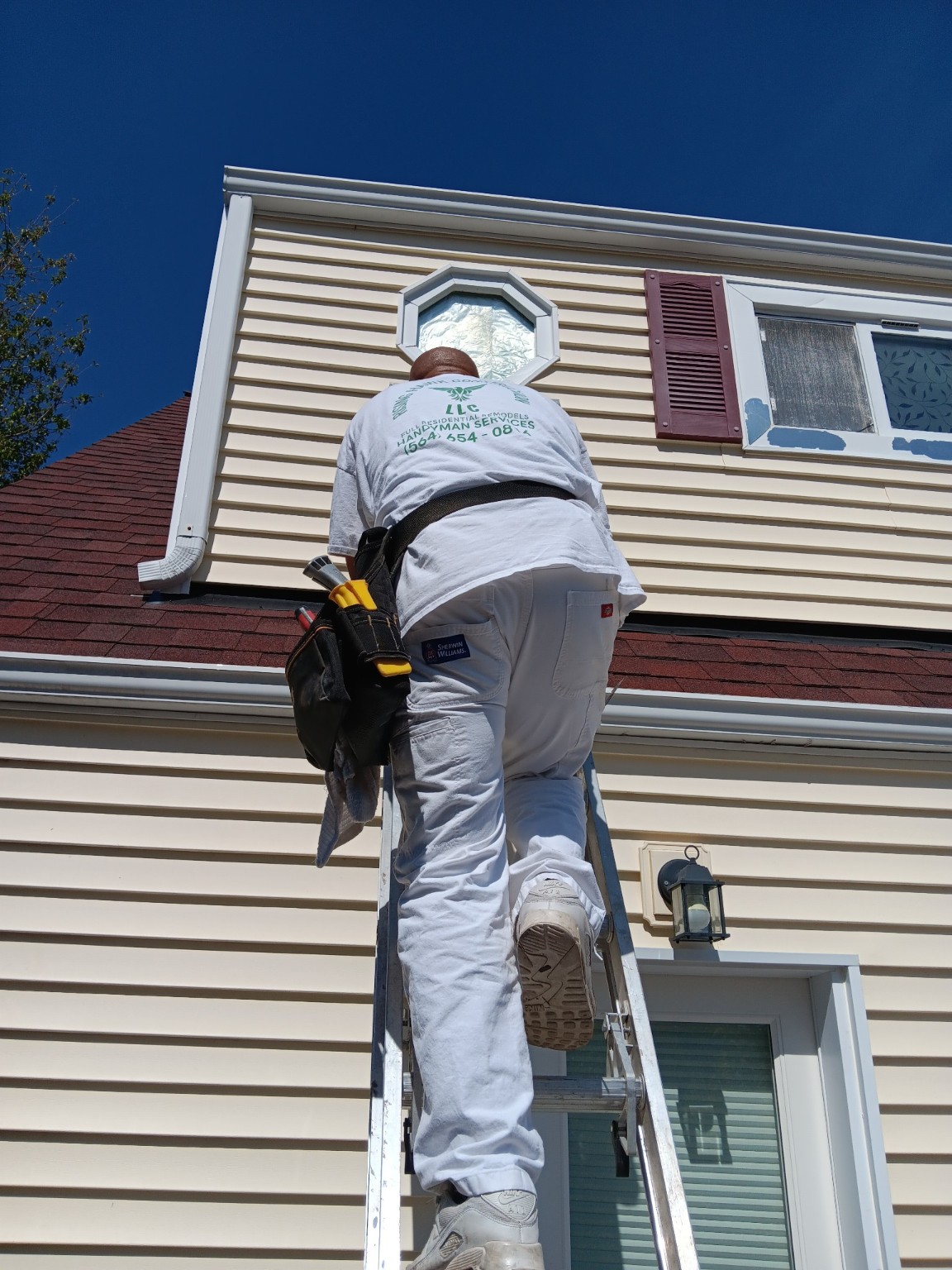 Rising Hawk Construction inspecting elevated window trim