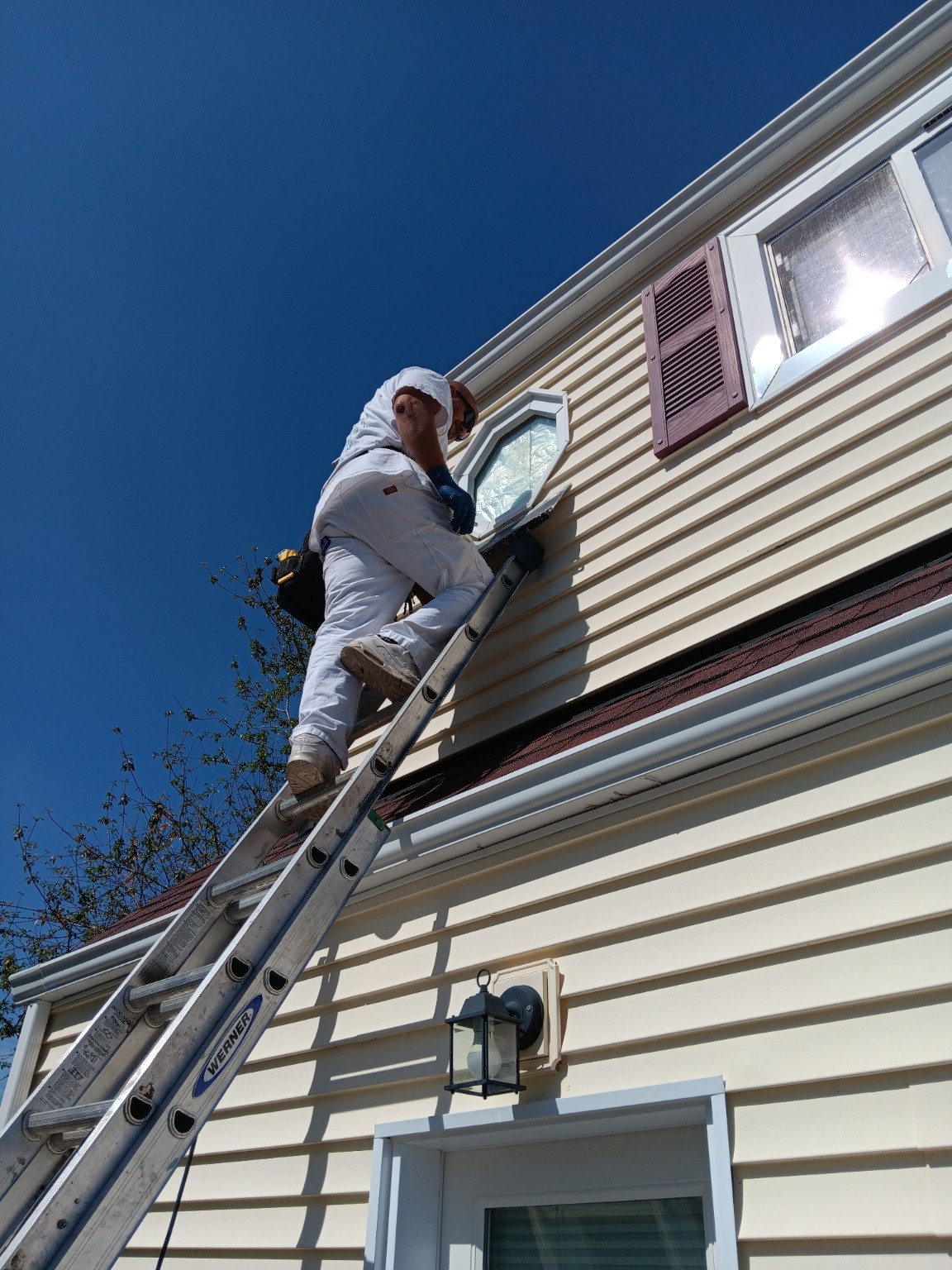 Exterior window trim surface preparation from a ladder