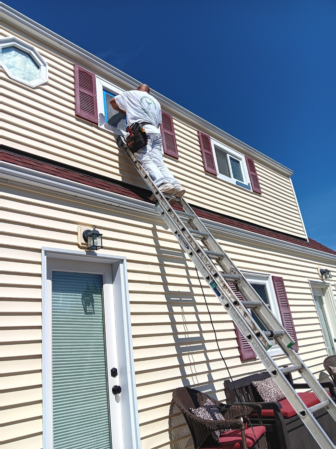 Rising Hawk Construction repairing second-story window trim